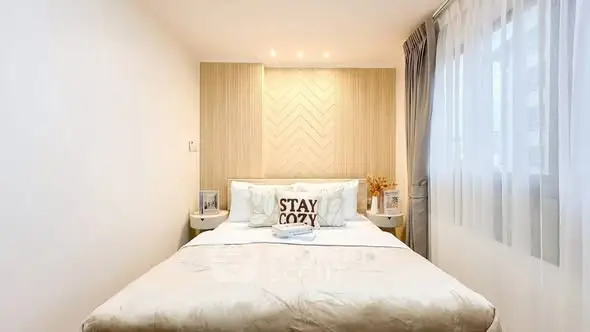 Cozy and inviting bedroom with modern decor and ample natural light.