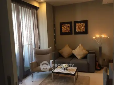 Cozy living room with modern decor and natural light from balcony.