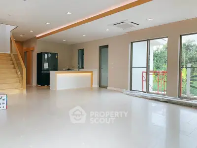 Spacious modern living room with open kitchen and large windows