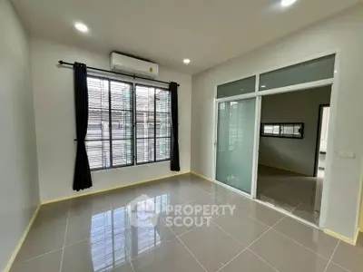 Spacious modern room with large windows and sleek tile flooring, perfect for natural light lovers.