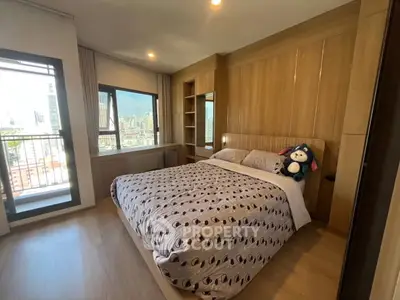 Spacious bedroom with city view and modern wooden furnishings