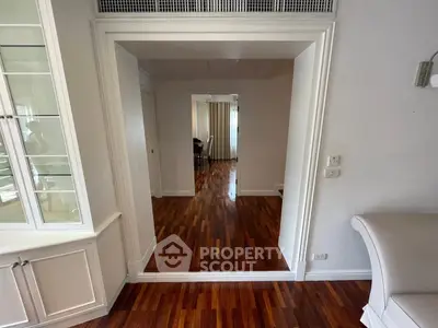 Spacious interior with elegant wooden flooring and stylish white cabinetry, perfect for modern living.