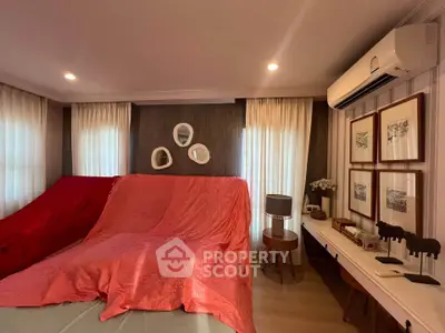 Cozy bedroom with elegant decor and air conditioning, featuring stylish wall art and ambient lighting.