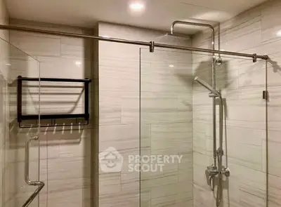 Modern bathroom with glass shower enclosure and sleek fixtures