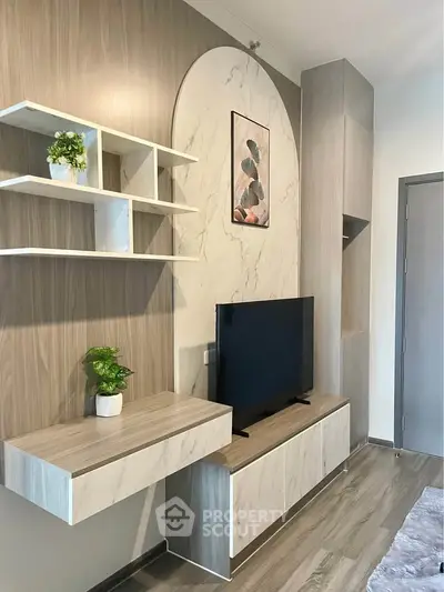 Modern living room with stylish TV unit and decorative shelves