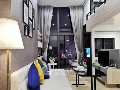 Modern living room with high ceilings and city view, featuring stylish decor and cozy seating area.