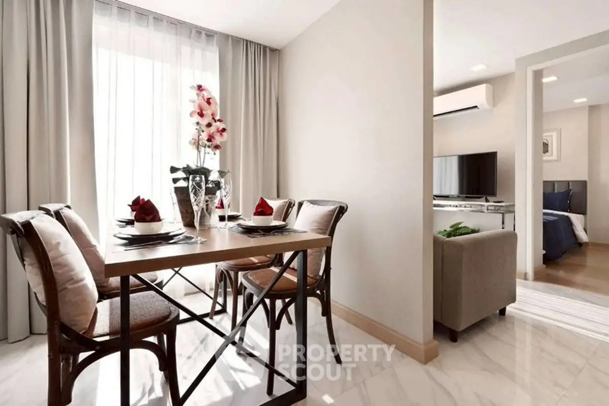 Elegant dining area with natural light and modern decor in a stylish apartment.