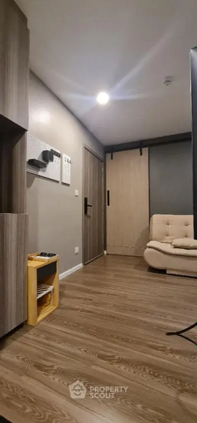 Modern living room with wood flooring and cozy beige sofa