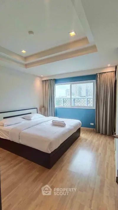 Spacious bedroom with city view and modern decor