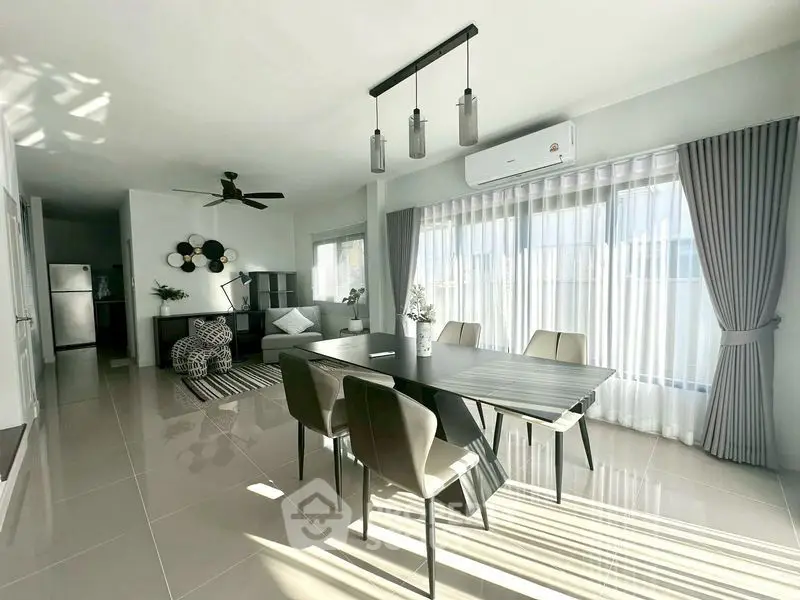 Modern open-plan living and dining area with sleek furnishings and abundant natural light.