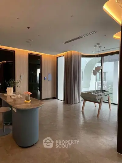 Luxurious modern living room with elegant decor and panoramic windows offering stunning views.