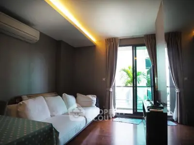 Modern living room with cozy sofa and balcony view in stylish apartment