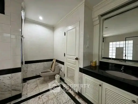 Luxurious marble bathroom with elegant fixtures and spacious design