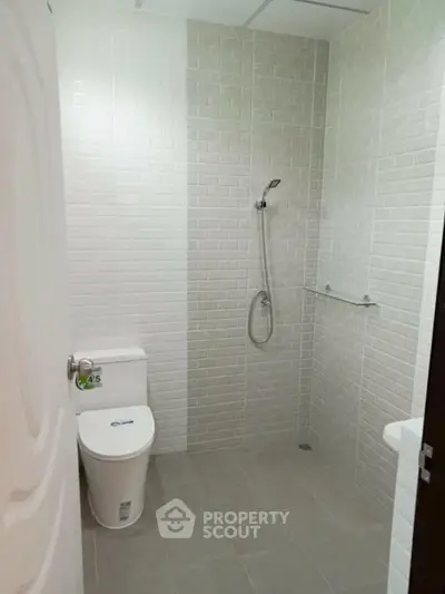 Modern bathroom with sleek shower and white tiles