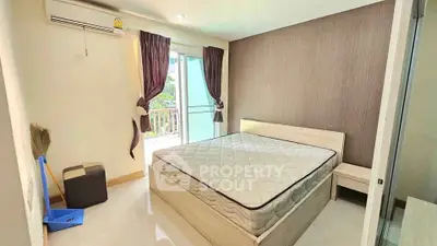 Bright bedroom with balcony access and modern decor