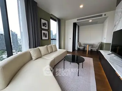 Modern living room with city view, featuring sleek furniture and elegant decor.