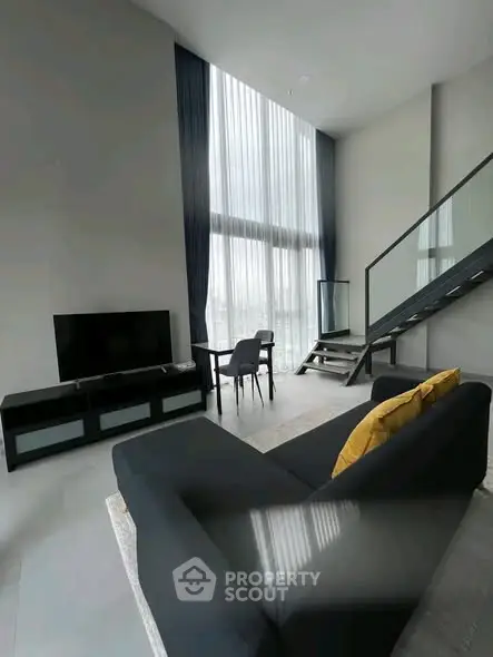 Modern loft living room with high ceilings and stylish furniture