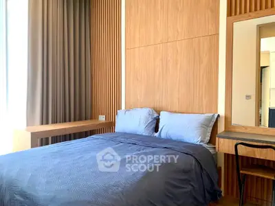 Modern bedroom with wooden paneling and cozy bedding in a stylish apartment.
