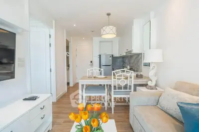 Charming open-layout living room with modern kitchen, cozy sofa, and elegant dining area, perfect for urban living.