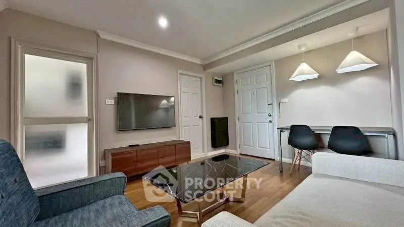 Modern living room with stylish furniture and wall-mounted TV