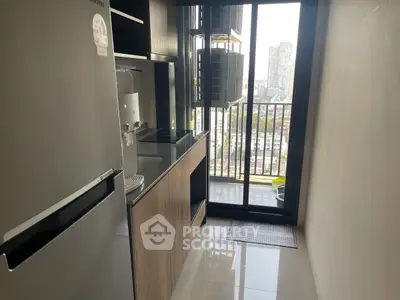 Modern kitchen with sleek appliances and city view from balcony