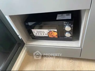Modern kitchen with built-in microwave oven in sleek cabinetry.