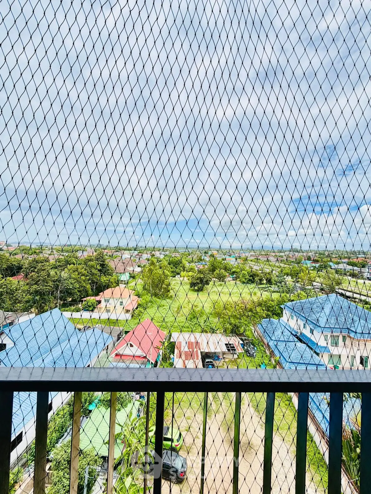 Stunning balcony view with lush greenery and expansive sky