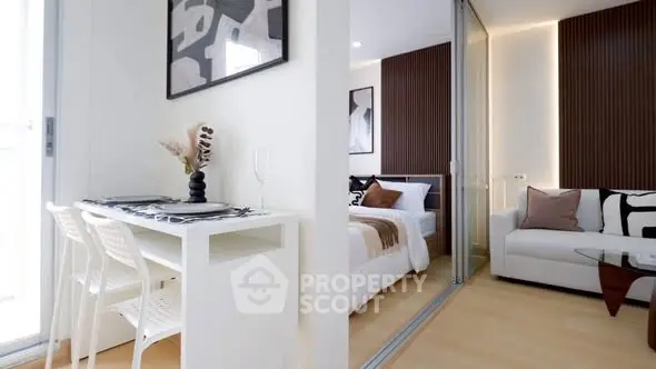 Modern open-plan living room with stylish decor and cozy bedroom