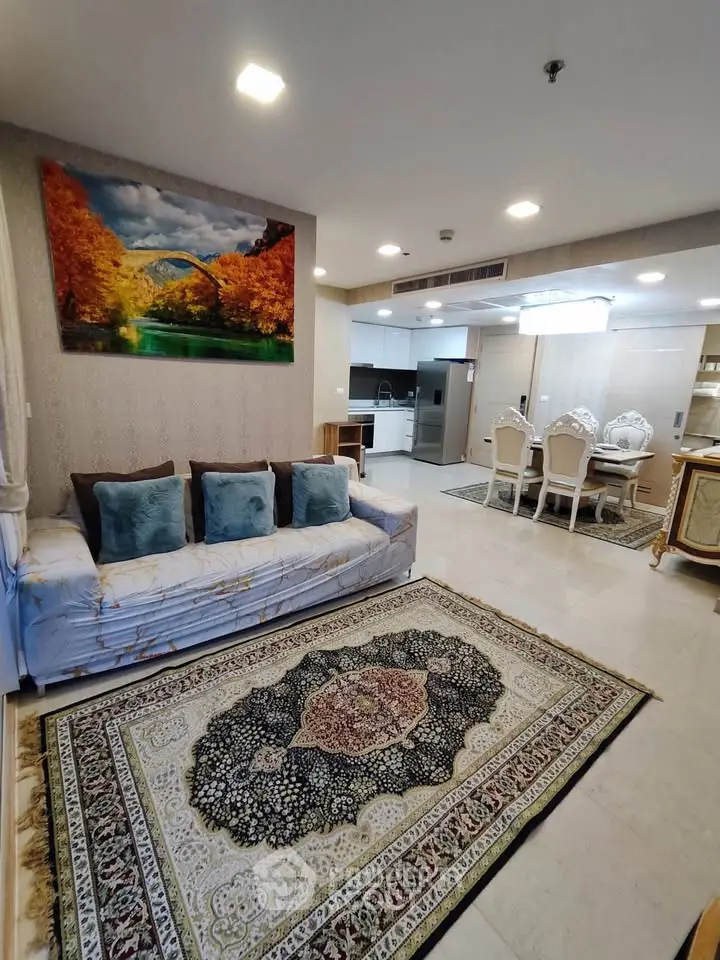 Spacious living room with elegant decor and open kitchen layout in modern apartment.