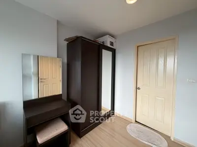 Cozy bedroom with wardrobe and vanity in modern apartment