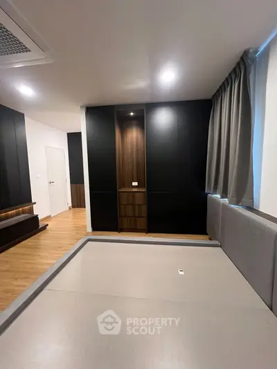 Modern bedroom with sleek design and built-in storage in a stylish apartment.