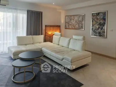 Spacious modern living room with elegant white sectional sofa and stylish decor