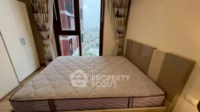 Modern bedroom with large window and city view