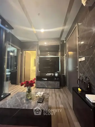 Modern living room with sleek marble decor and elegant lighting