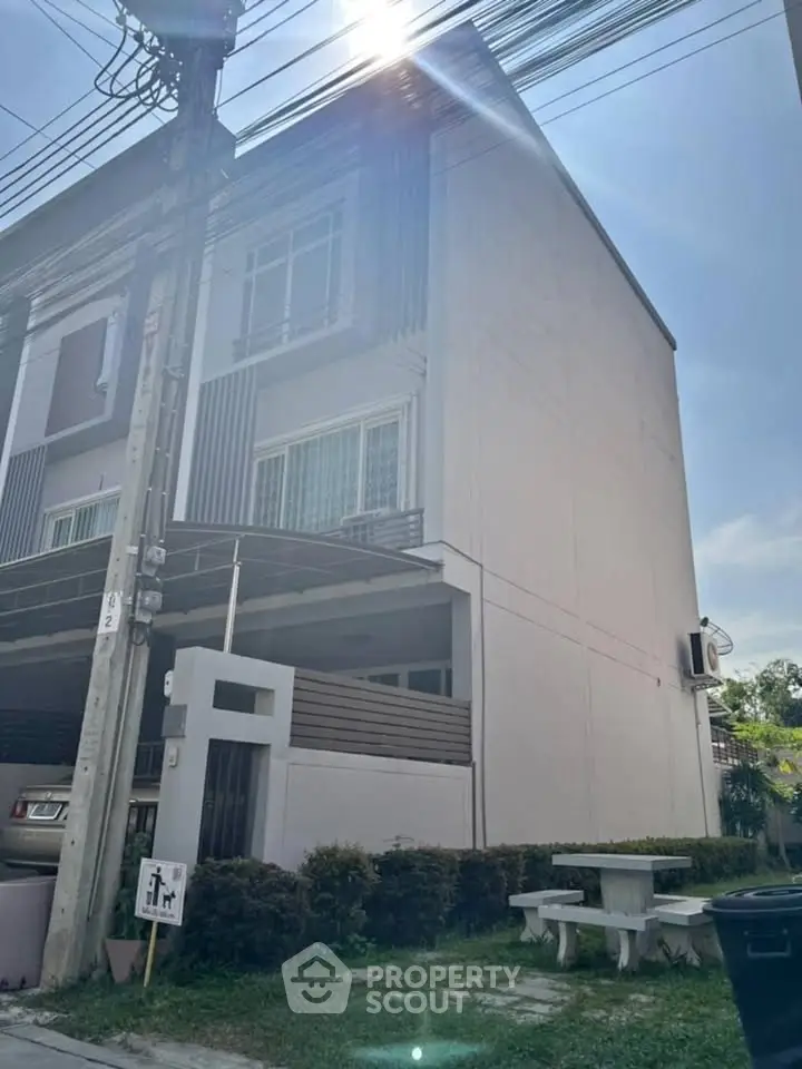 Modern townhouse exterior with clean lines and ample natural light, perfect for urban living.