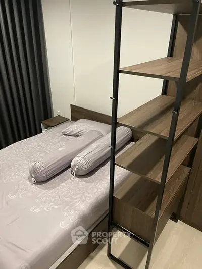 Modern bedroom with stylish shelving and elegant bedding in a cozy setting.