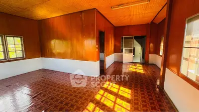 Spacious wooden interior room with natural light and patterned flooring