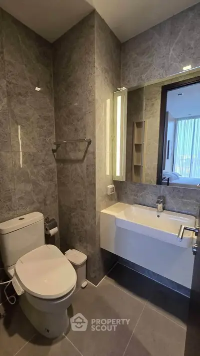 Modern bathroom with sleek fixtures and elegant gray marble tiles