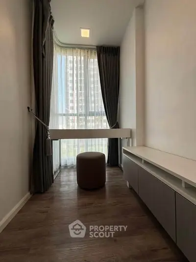 Modern minimalist room with floor-to-ceiling window and elegant curtains, perfect for a cozy reading nook.