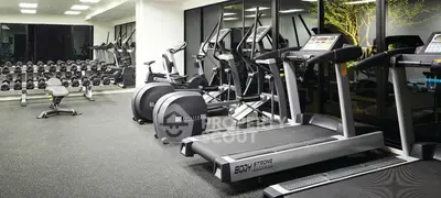 Modern gym with state-of-the-art equipment in a luxury residential building.