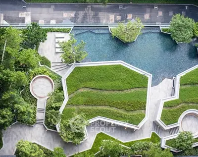 Stunning aerial view of modern landscaped garden with water features and lush greenery.