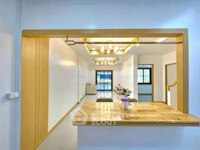 Modern open-plan living space with wooden accents and stylish lighting.