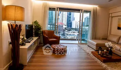 Spacious modern living room with city view balcony, elegant decor, and cozy seating area.