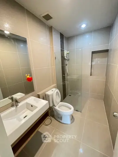 Modern bathroom with sleek tiles and glass shower enclosure