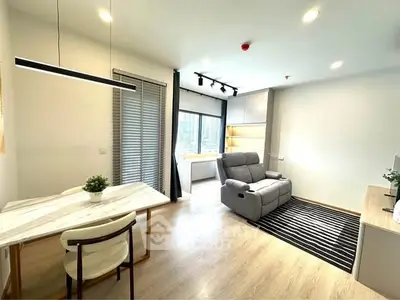 Modern living room with sleek furniture and natural light, perfect for urban living.