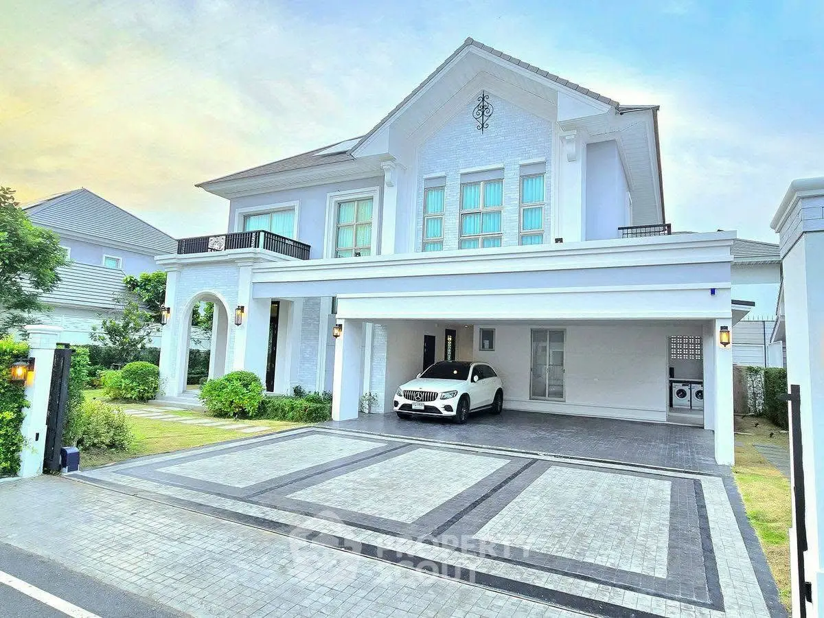 Luxurious white mansion with spacious driveway and elegant architecture