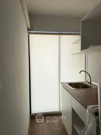 Compact kitchen with sleek design and modern sink, ideal for small apartments.