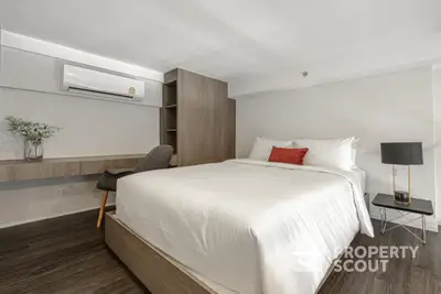 Modern bedroom with stylish decor and air conditioning in a cozy apartment.