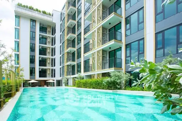 Luxurious modern apartment building with a stunning outdoor pool and lush greenery.
