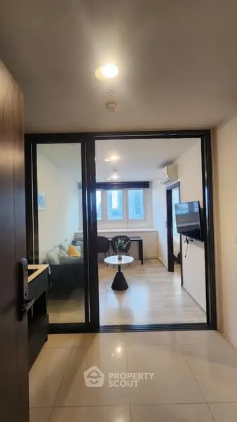 Modern living room with glass partition and stylish decor